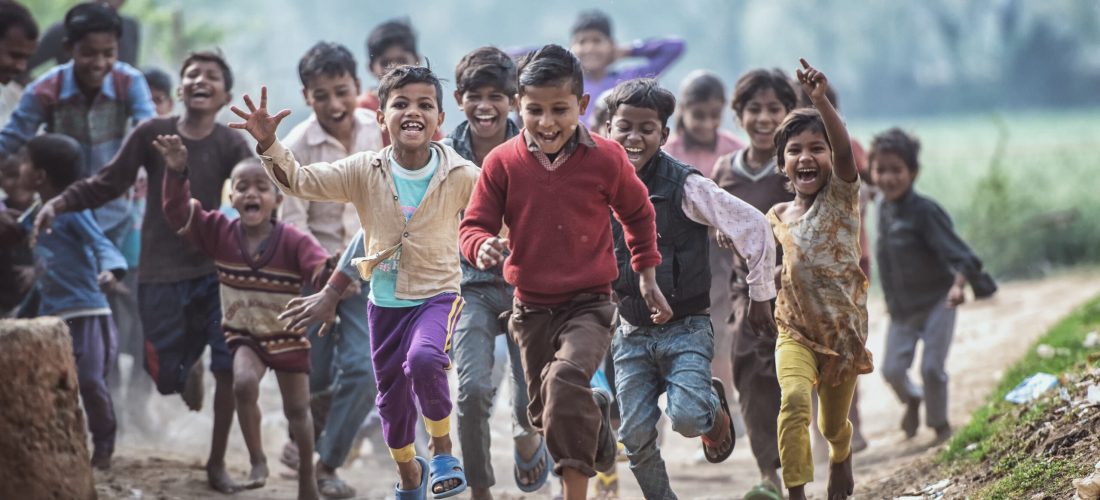 MATHURA, INDIA - Feburary 23,2018: Group of boisterous Indian children running for photograph in Agra, Uttar Pradesh, India.